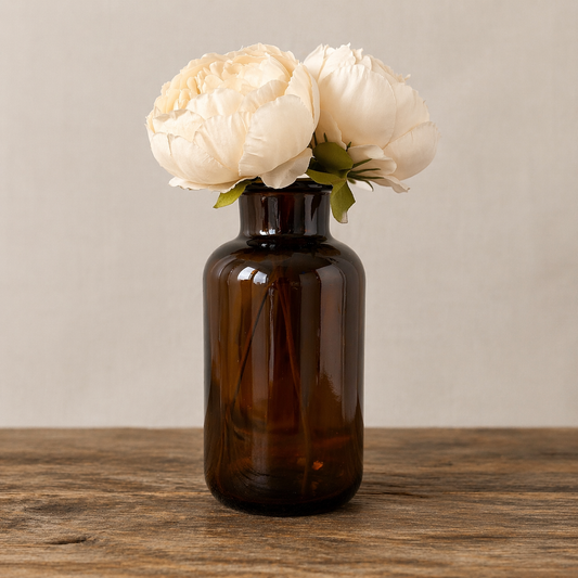 Collected Amber Glass Bottle with Floral Arrangement